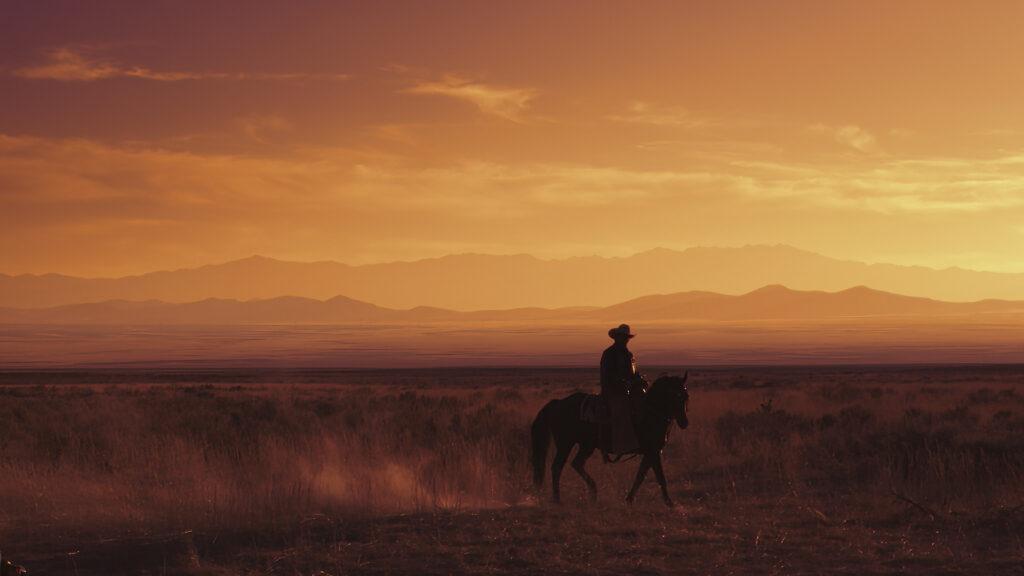 A Tejano cowboy rides across the Texas landscape at sunset. (National Geographic)