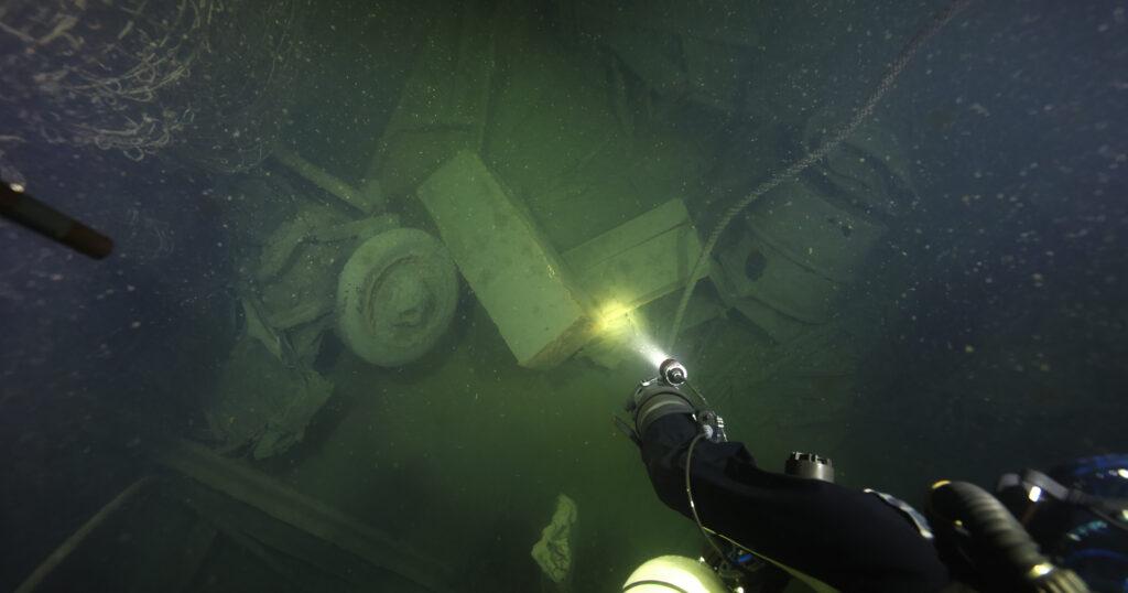 A diver goes down to salvage one of the crates in the cargo hold of the Karlsruhe. (National Geographic/Sami Paakkarinen)